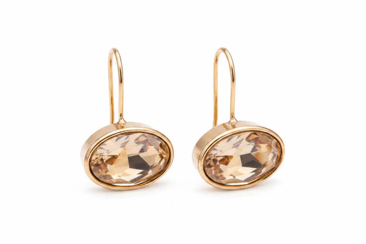 Gold oval crystal drop earrings horizontal gem white background