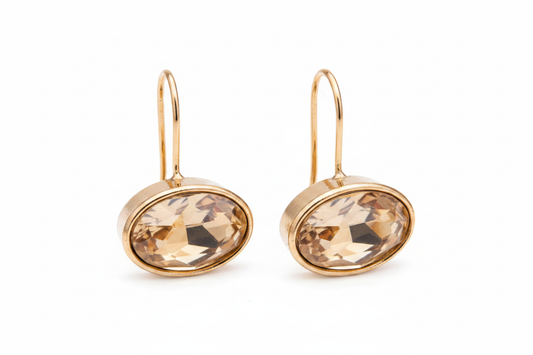 Gold oval crystal drop earrings horizontal gem white background
